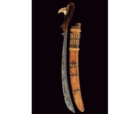 A mandau dating: mid-19th Century provenance: Borneo Strong, wide, curved, single-edged blade with grooves and engravings at 