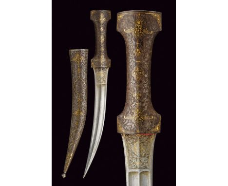 A kandshar dating: 19th Century provenance: Persia Curved, double-edged blade with raiser at the center; engraved and gilt wi