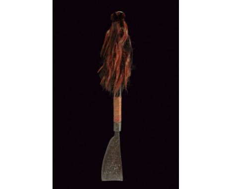 A Konyak war axe dating: 19th Century provenance: India Iron head with wide, single-edged blade; long, wooden grip decorated 