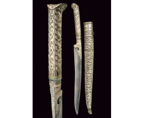 A silver mounted bichaq dating: late 19th Century provenance: Turkey Slightly-curved, single-edged blade. Silver grip, decora