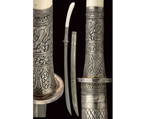 An elegant silver mounted Dha dating: 19th Century provenance: Burma Strong, curved, single-edged blade, slightly narrowed to