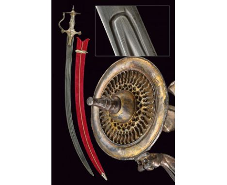 A silver-plated mounted tulwar dating: early 19th Century provenance: India Curved, damask, single-and false-edged blade with