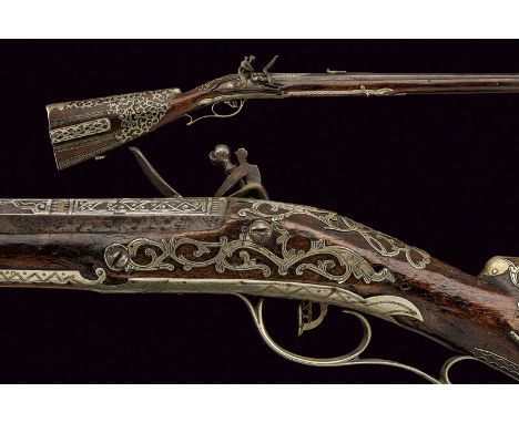 A silver mounted flintlock rifle dating: 18th Century provenance: Europe Octagonal, rifled, 15 mm cal. barrel with adjustable