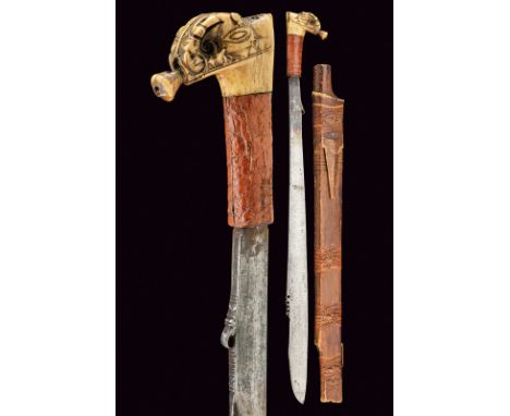 A mandau dating: circa 1900 provenance: Borneo Strong straight, single-edged blade, partially pierced at the back, curled at 