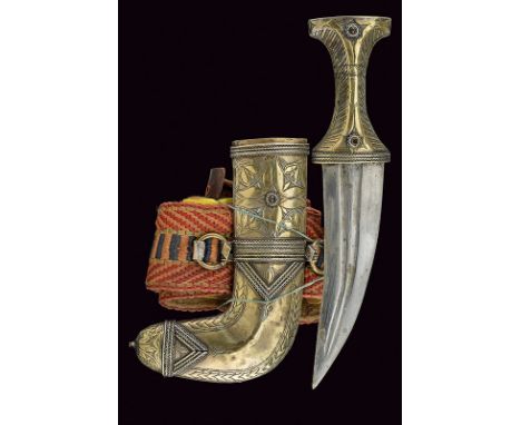 A Jambyia with scabbard and belt dating: circa 1900 provenance: Arabia Short, curved, double-edged blade with two grooves and