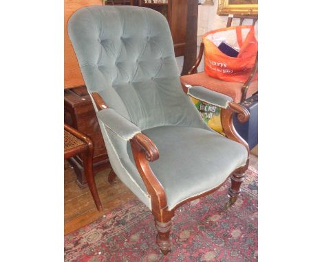 Victorian armchair with scroll arms and upholstered in teal fabric