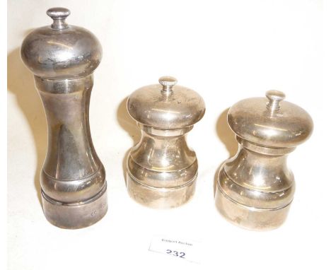 Two silver pepper and salt mills and a taller pepper mill (approx 6")