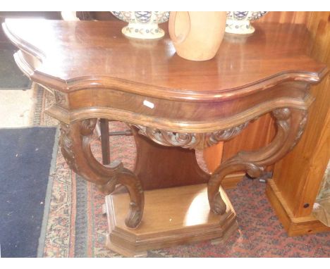 Reproduction mahogany console/hall table with shaped top above carved legs