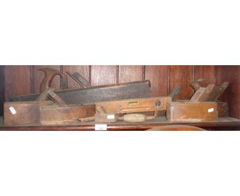 Six various wooden block planes and a level
