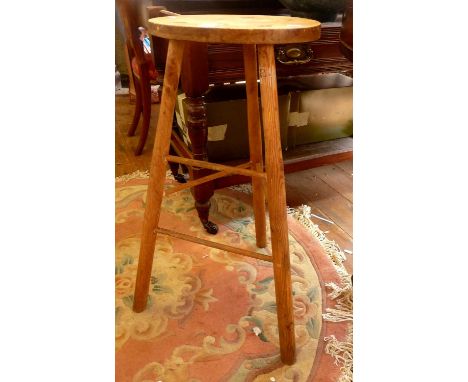 Pine and elm stool on three legs with stretchers
