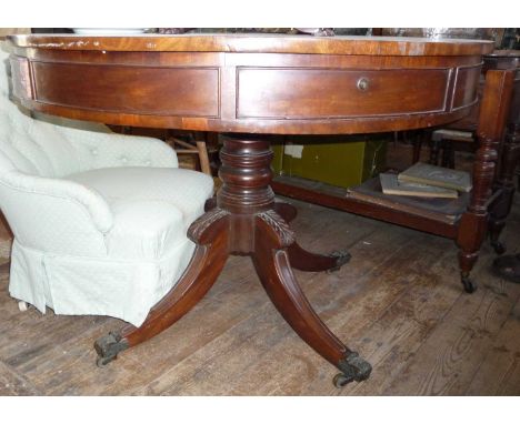 Georgian mahogany drum table with 4 drawers above a turned column on quadruple hipped sabre legs with brass cappings and cast
