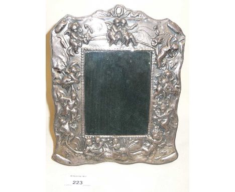 Victorian style Britannia silver photo frame with easel back, decorated with repousse cherubsHallmarked for Birmingham 2002, 