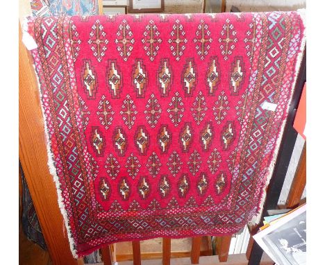 Small Persian rug on red ground