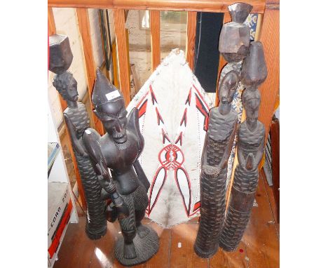 Tribal Art - four large carved wood African figures and a painted Masai cowhide shield 