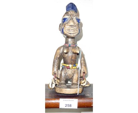 Tribal Art - a Yoruba.ibedji twin figure with beads and cowrie shells, 25cm
