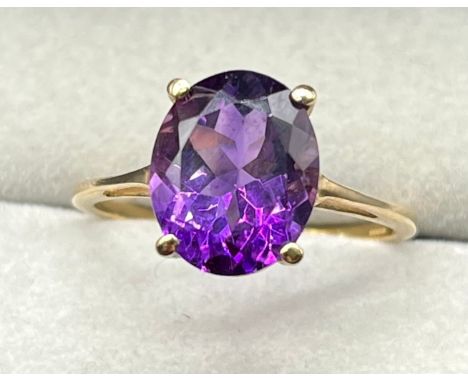 10ct yellow gold ring set with an oval cut Amethyst gem stone. [Ring size P] [2.59Grams] 