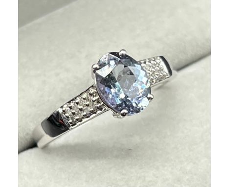 10ct white gold ring set with a blue Iolite gem stone and diamond shoulders. [Ring size P] [2.64Grams] 