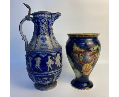 An Antique German Westerwald salt glaze months of year pitcher jug and a Carlton ware created bird and waterlilly pattern vas