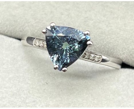 10ct white gold ring set with a blue triangle shaped gem stone and diamond shoulders. [Ring size P] [2.49Grams] 