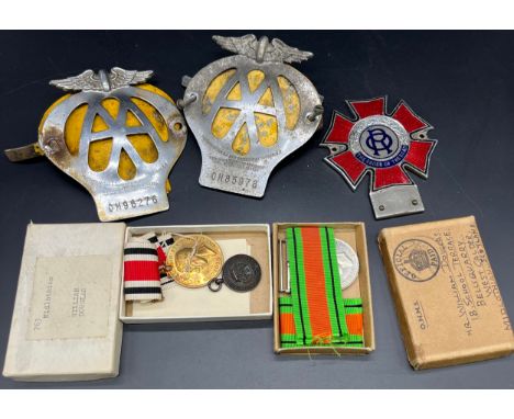 Two boxed Military medals together with three various car badges; The Order of the Road enamel car badge. 