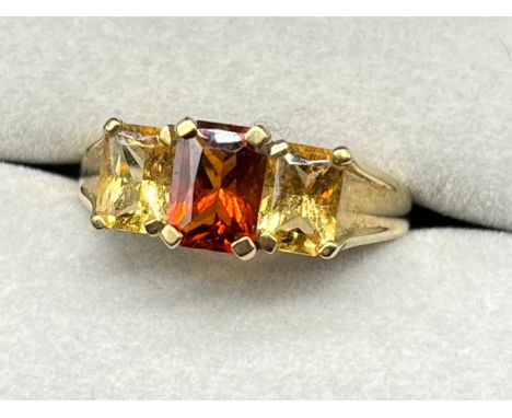 9ct yellow gold ring set with three emerald cut citrine gem stones- orange and two yellow citrine stones. [Ring size M] [2.98