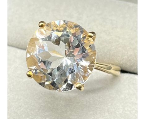 9ct yellow gold ring set with a large round cut white topaz gem stone. [Ring size M] [5.71Grams] 