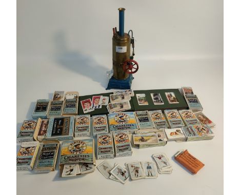 A vintage steam donkey engine together with a large collection of cigarette cards including football, steam engines and anima