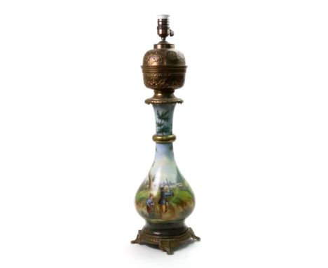A Paris porcelain gilt metal mounted oil lamp, late 19th century, the pear shape body painted with a hunting scene and river 