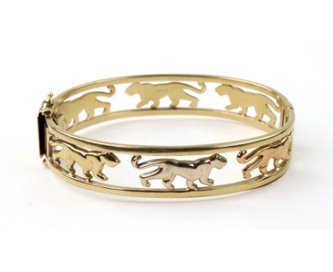 A 9ct yellow gold hinged bangle with open work design of three colour gold walking panthers, clip stamped '375', 18.5g (a.f.)