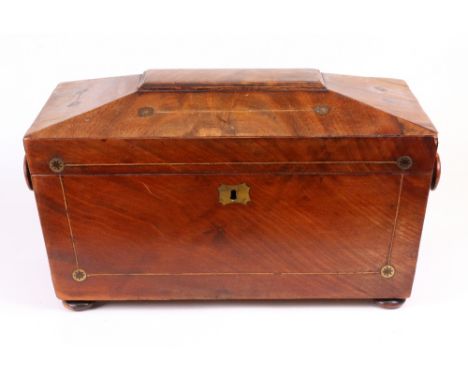 A Regency mahogany boxwood strung sarcophagus shape tea caddy, with cut-brass roundels, the hinged cover enclosing a fitted i