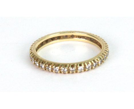 A diamond eternity ring, claw-set with a row of brilliant-cut diamonds, ring size Q/R and a half,  3.1g gross.