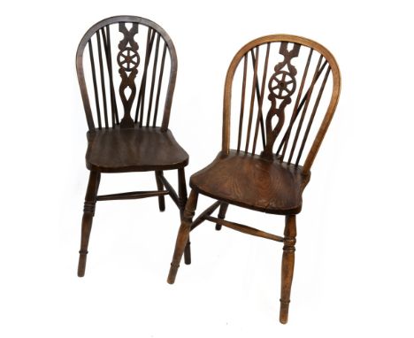 A harlequin set of ten beech, ash and elm Windsor chairs, with stick and wheel backs, on turned legs, early 20th century and 