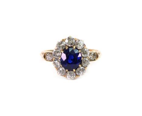 An early 20th century sapphire and diamond cluster ring, the oval mixed-cut sapphire (approx. 1.25cts) claw-set within a ten-