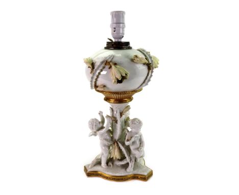 A Moore Brothers porcelain oil lamp, white glazed, heightened with gilding and applied with yellow lilies, the compressed cir