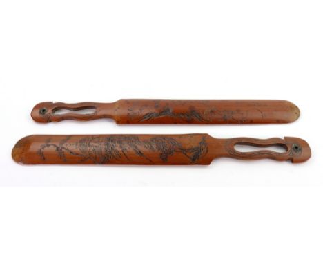 A pair of Chinese bamboo page turners, late 19th/early 20th Century, one incised and carved with a figure on a horse, the oth