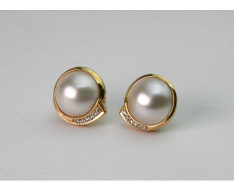A pair of modern diamond and mabé pearl ear studs, each with six graduating diamonds and post and butterfly clip fittings, th
