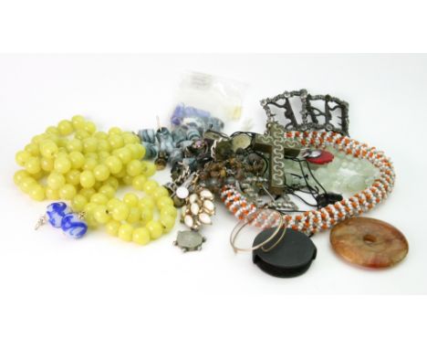 A Chinese pale green 'jade style' glass bead necklace of varying size beads, the larger beads with 'carved' swirls, ring term