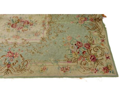 A large French tapestry wall hanging, 19th century, centred by a rectangular section of flowers and leaves surrounded by a bo