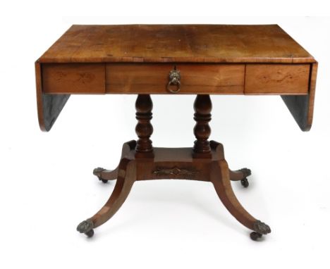 A Regency rosewood sofa table, with single frieze drawer, hinged drop leaves, on twin baluster turned columns, and gilt metal