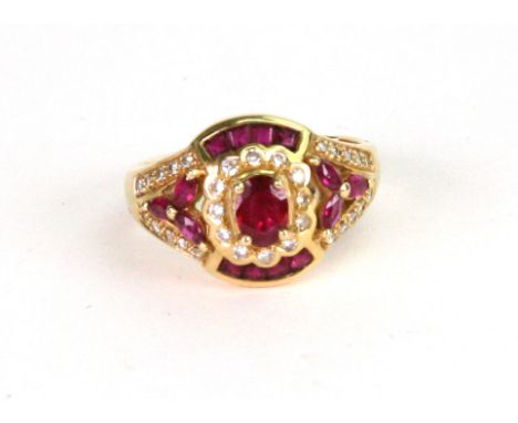 A ruby and diamond cluster ring, the oval mixed-cut claw-set ruby within a diamond flowerhead shaped surround, with ruby set 