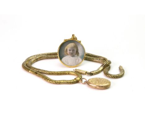 A 9ct gold locket, with scrolling and floral decoration, Birmingham 1901, on an associated Brazil-link neck chain, and a doub