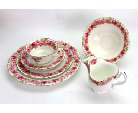 A Royal Doulton tea service painted with red roses, pattern no. HB 7114, 29 pieces.