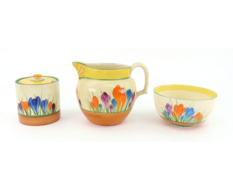 A Clarice Cliff Bizarre Crocus pattern jug, 10.5cm high, a Crocus pattern preserve jar and cover, 7.5cm high, and a Crocus pa