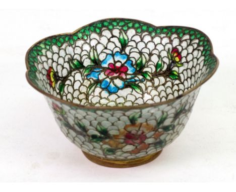 A small plique a jour bowl, of flowerhead shape, on a gilt metal rim foot, decorated with two flowering branches and a centra