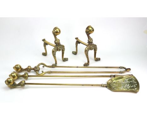 A set of three reproduction brass fire tools, with cast claw and ball capitals, 71cm long and a pair of matching fire dogs (5