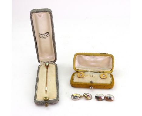 A pair of yellow and white metal, ruby and diamond set cufflinks, early 20th century, 10.6g gross, unmarked, cased, a pair of