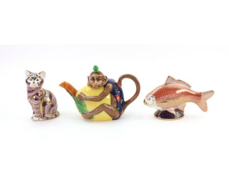 A Minton Archive Collection Monkey teapot, No 266/1793, and two Royal Crown Derby paperweights Golden Carp & Cat (3).