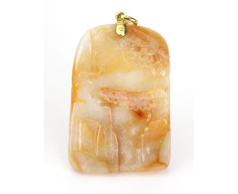 A carved mottled yellow jade pendant depicting a prowling lion and flowers, and a rocky landscape to the reverse, of arched t