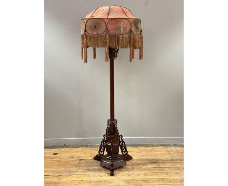 A Chinese Cherrywood floor lamp, 1920s, with centre turned column mounted on a hexagonal carved base, raised on triple-carved