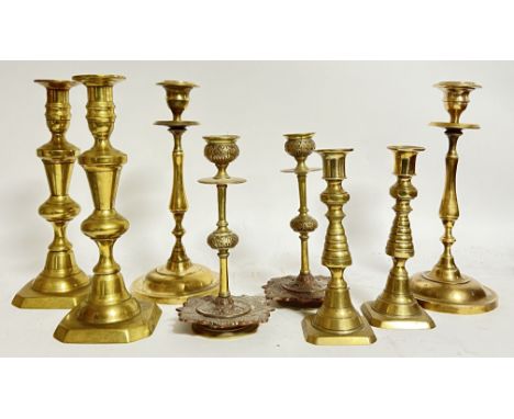 A mixed group of brass and copper candlestick holders of various sizes and forms (tallest h- 25.5cm) (8)